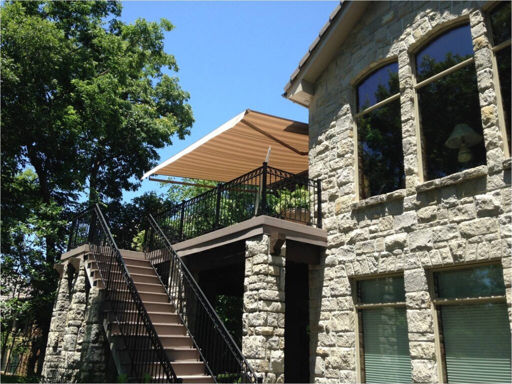Second-level deck for Pennsylvania home, shaded by a rich brown Sunesta awning on a bright Summer day.
