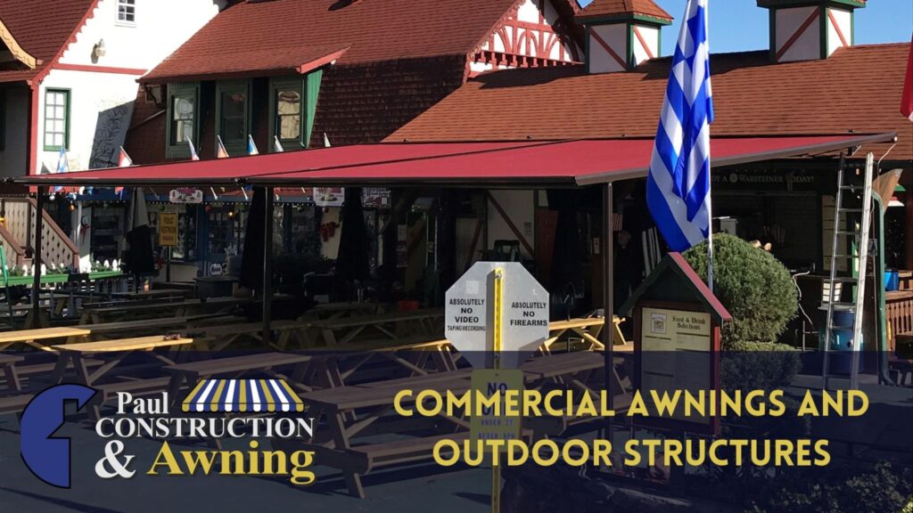 Red roof structure providing additional shade over a set of outdoor picnic tables for a commercial business.