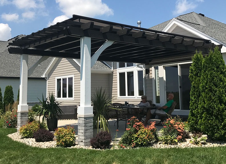 A Philadelphia couple enjoy their shaded outdoor space beneath a permanent roof structure.