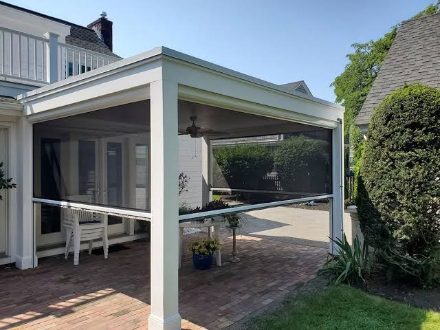 An outdoor shelter that is fully screened in with retractable screens, allowing for open air at all times, that is adjustable to the homeowner's needs.