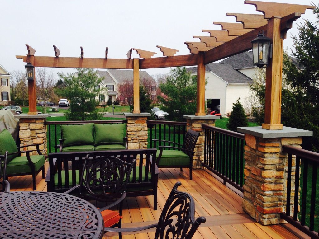 Cedar pergola over a deck with stone-clad columns