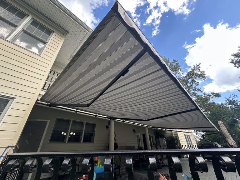 Striped retractable awning extended over a deck