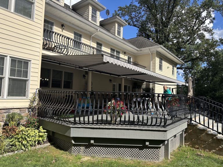 Retractable awning extended over an elevated deck